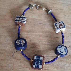 Vintage fun bracelet with blue beads and unique charms.